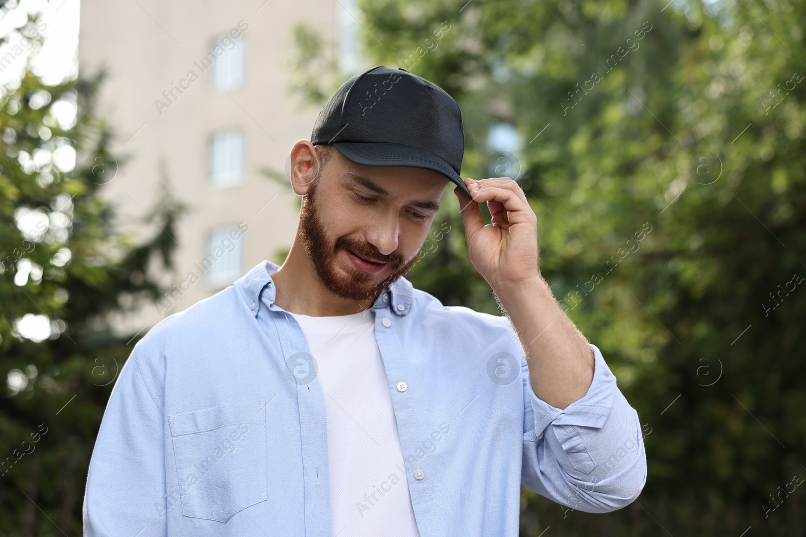 Photo of Portrait of handsome man in baseball cap outdoors