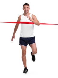 Man in sportswear crossing red finish line on white background