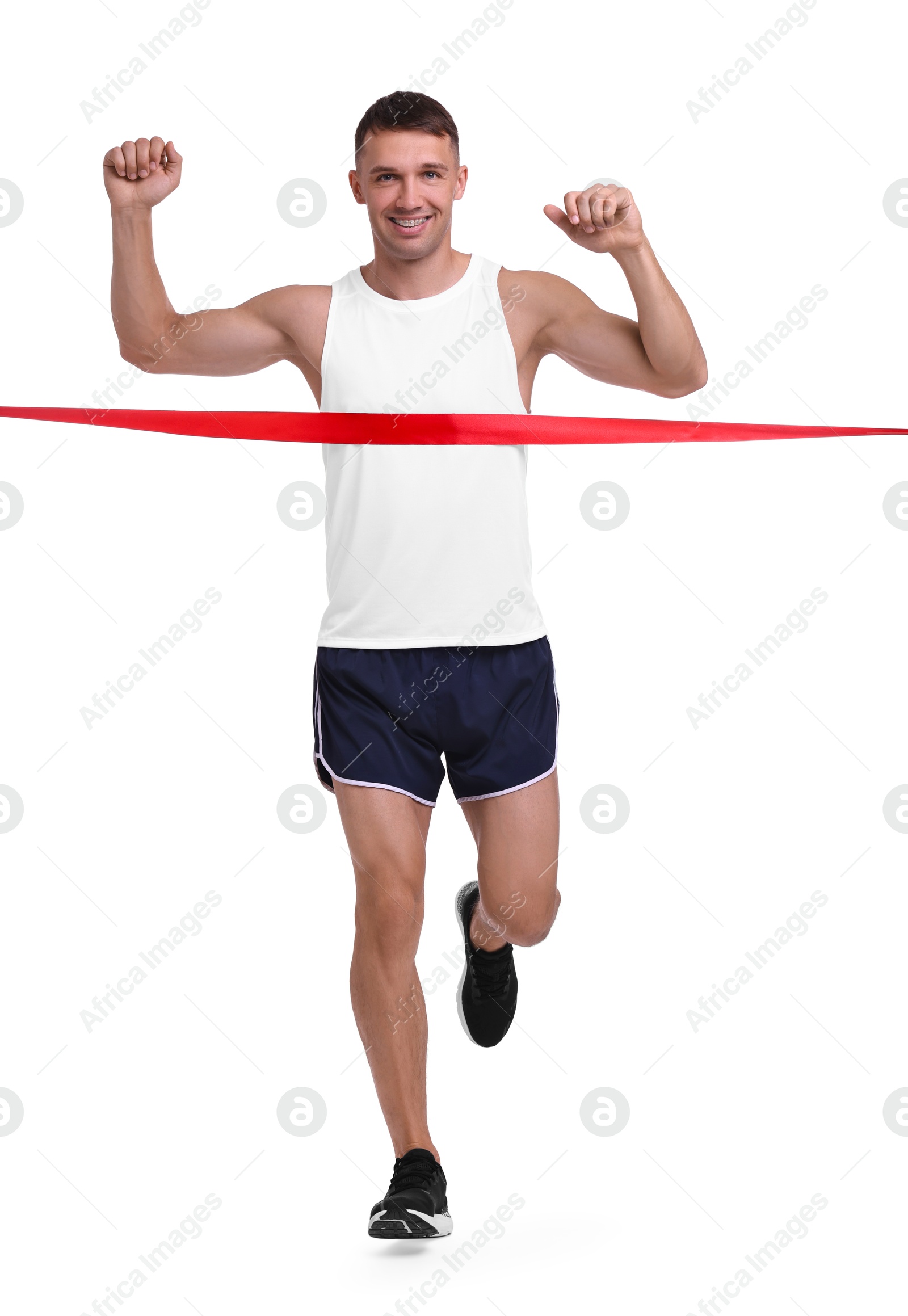 Photo of Man in sportswear crossing red finish line on white background