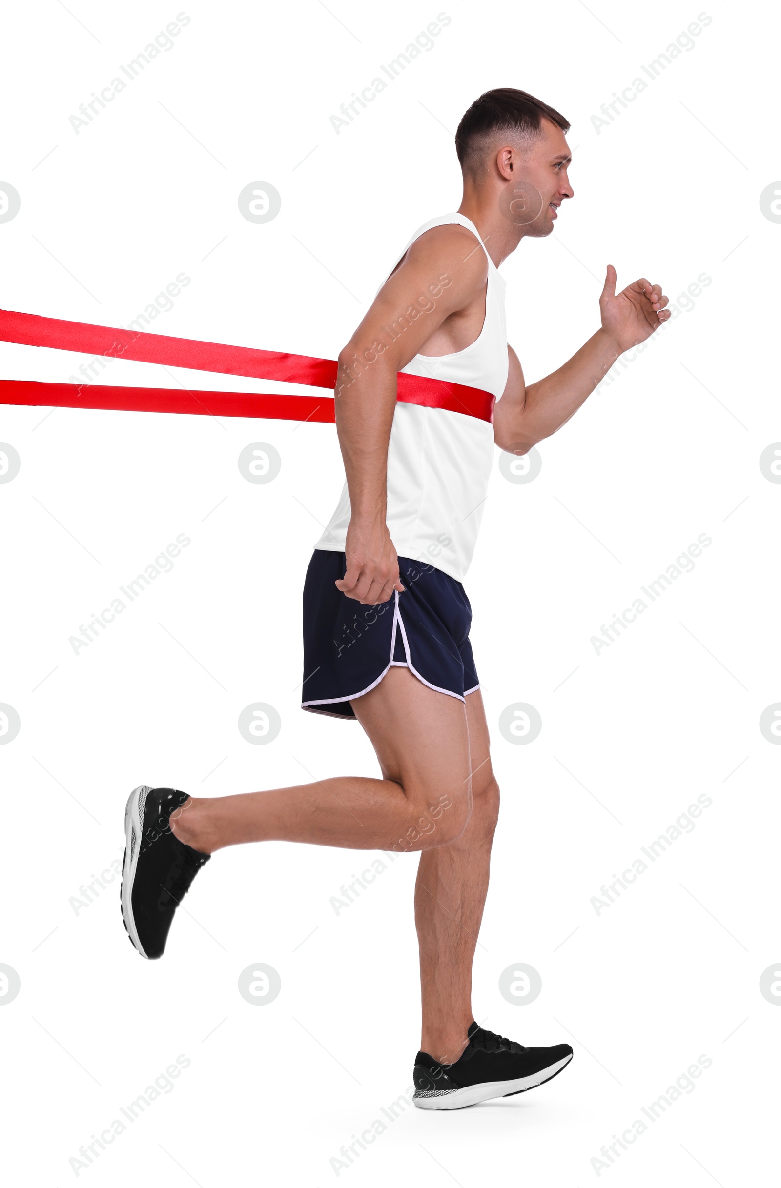 Photo of Man in sportswear crossing red finish line on white background