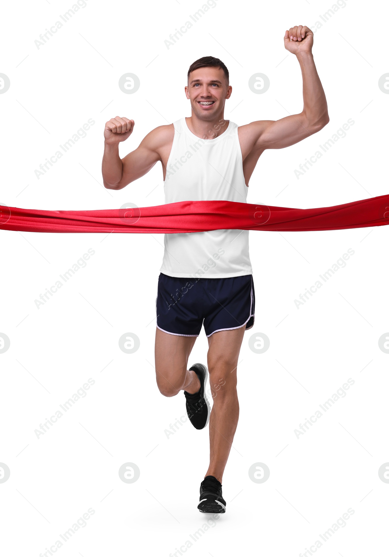 Photo of Man in sportswear crossing red finish line on white background