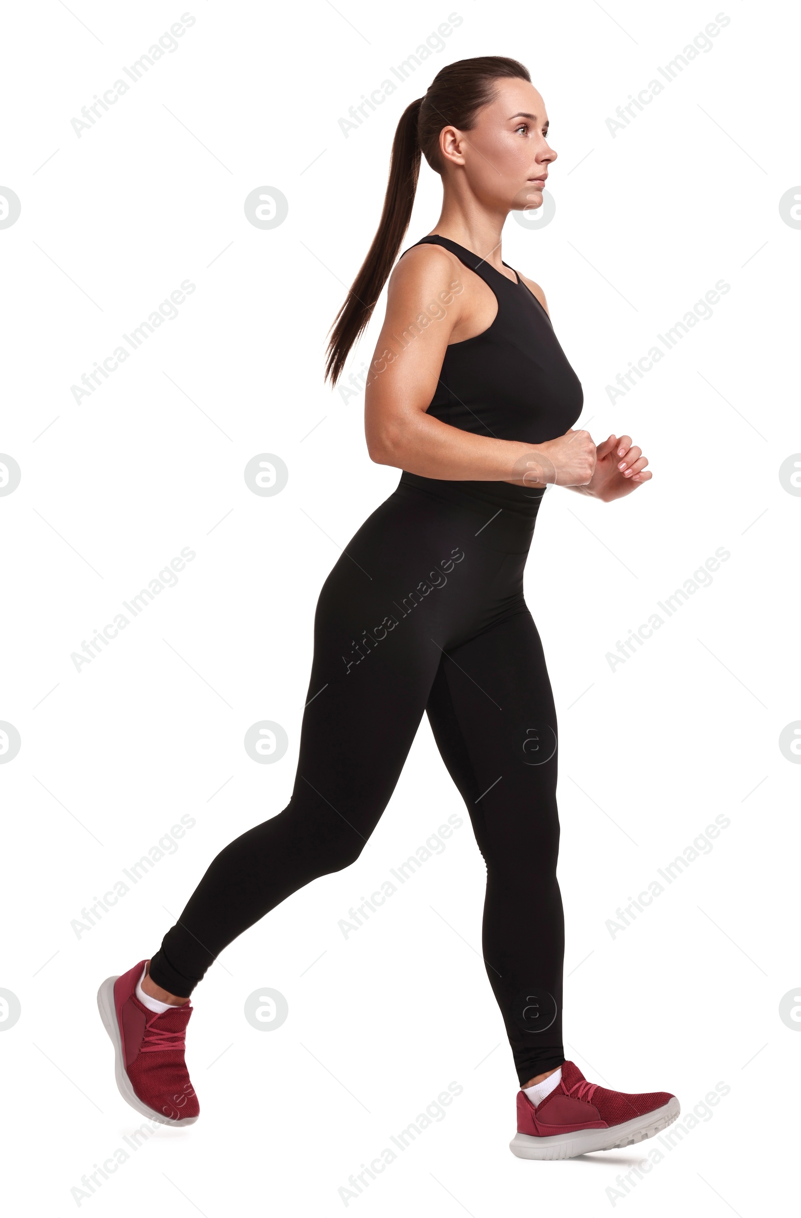 Photo of Woman in sportswear running on white background