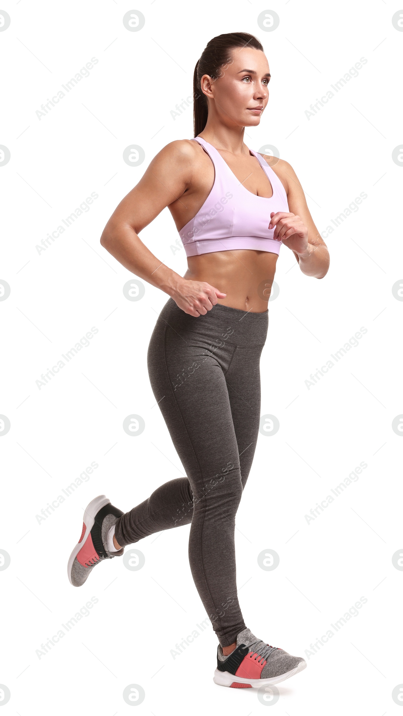 Photo of Woman in sportswear running on white background