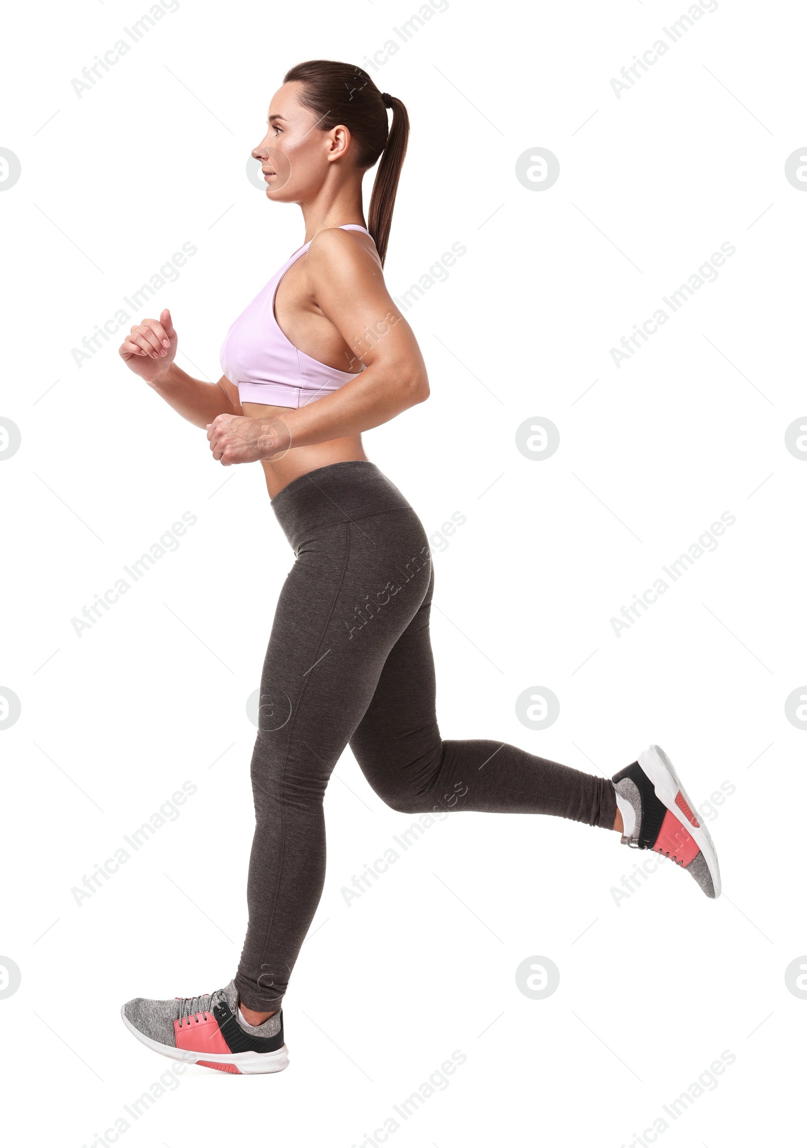 Photo of Woman in sportswear running on white background