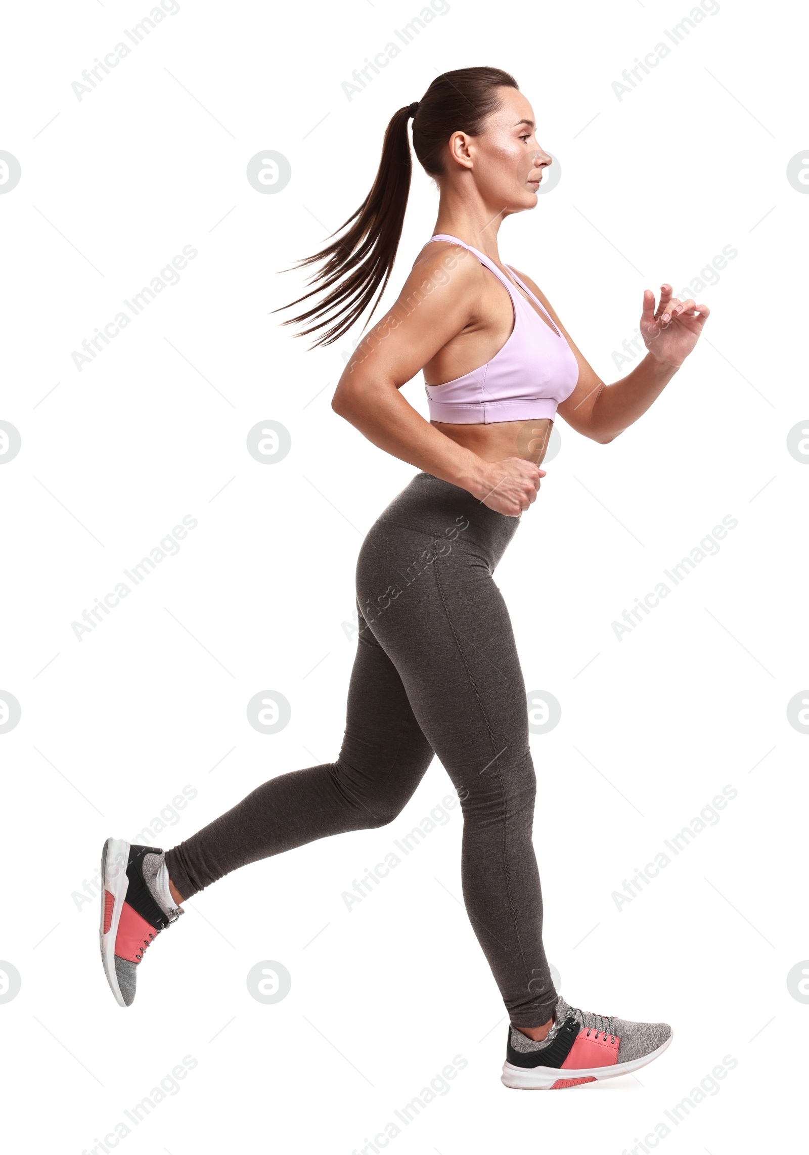 Photo of Woman in sportswear running on white background