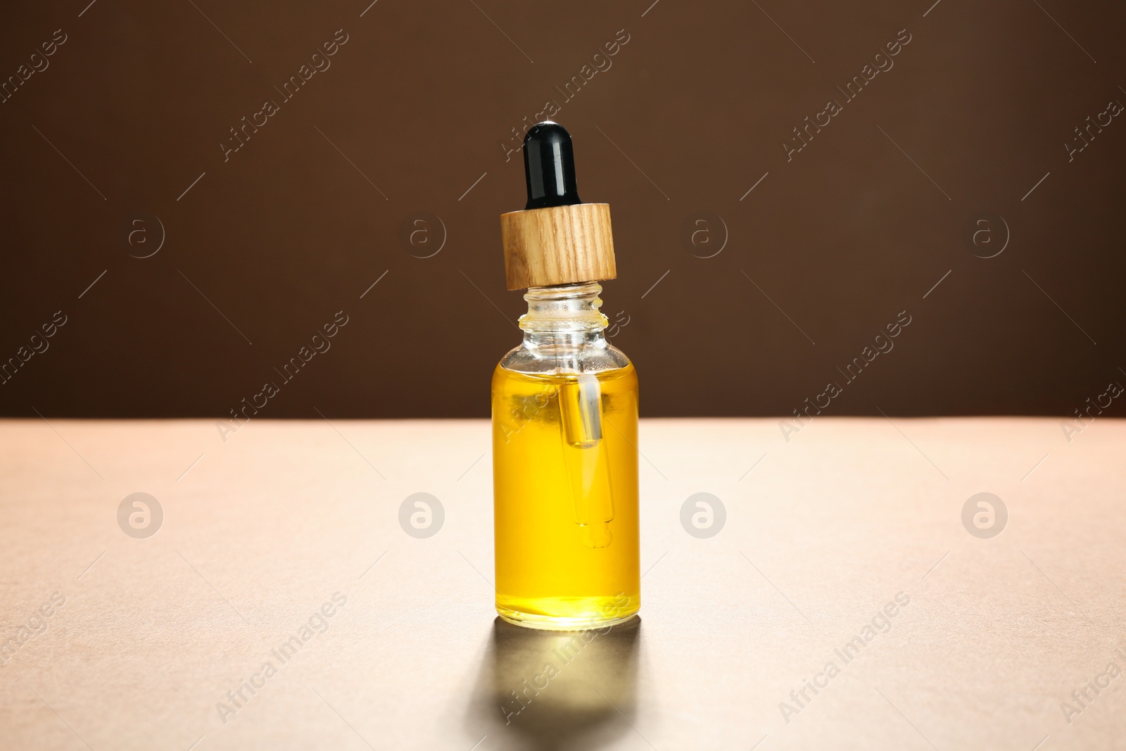 Photo of Natural tincture in bottle on beige background