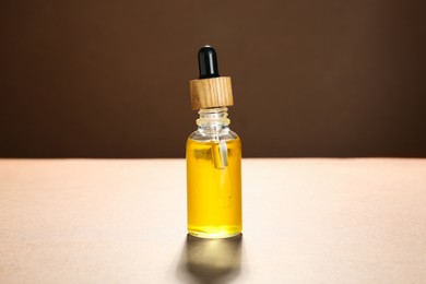 Natural tincture in bottle on beige background