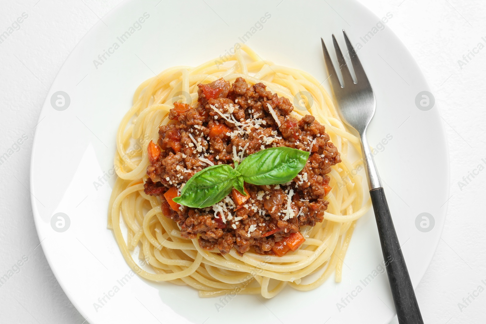 Photo of Tasty pasta bolognese on white table, top view