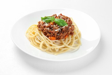 Photo of Plate with tasty pasta bolognese on white table, closeup