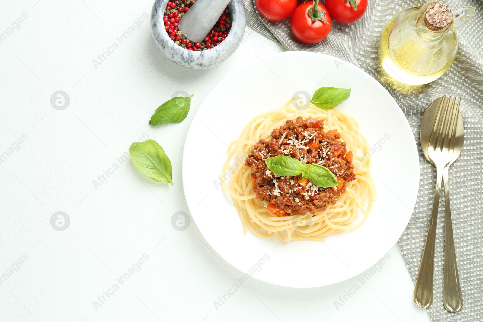 Photo of Tasty pasta bolognese served on white table, flat lay