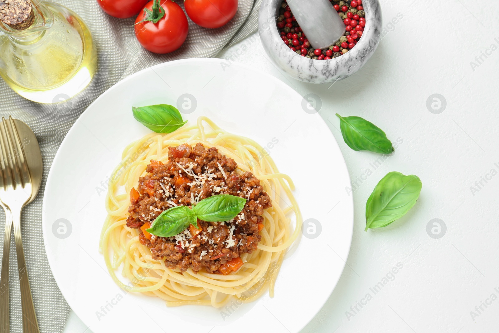 Photo of Tasty pasta bolognese served on white table, flat lay