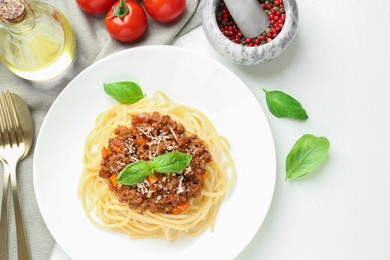 Photo of Tasty pasta bolognese served on white table, flat lay