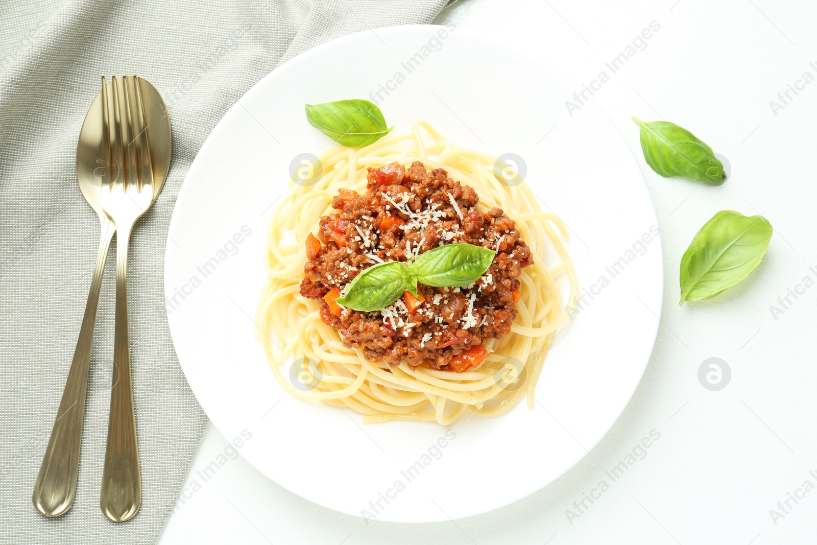 Photo of Tasty pasta bolognese served on white table, flat lay