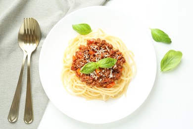 Photo of Tasty pasta bolognese served on white table, flat lay