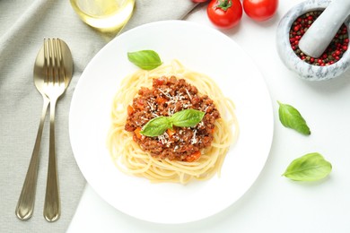 Photo of Tasty pasta bolognese served on white table, flat lay