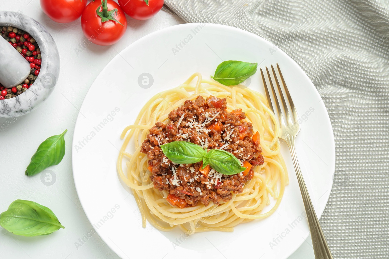 Photo of Tasty pasta bolognese served on white table, flat lay