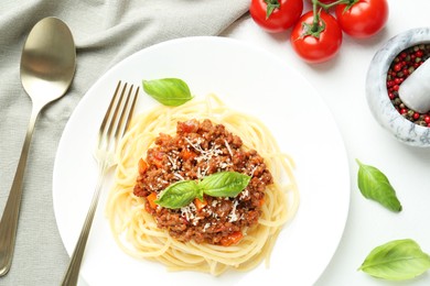 Photo of Tasty pasta bolognese served on white table, flat lay