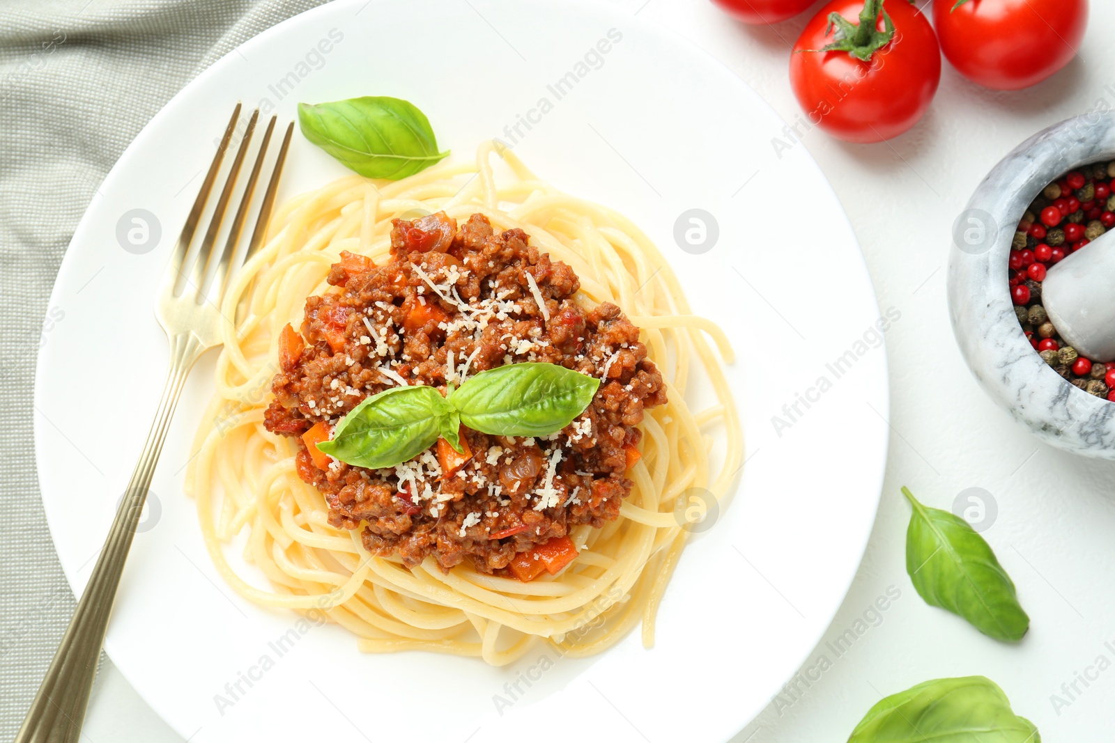 Photo of Tasty pasta bolognese served on white table, flat lay