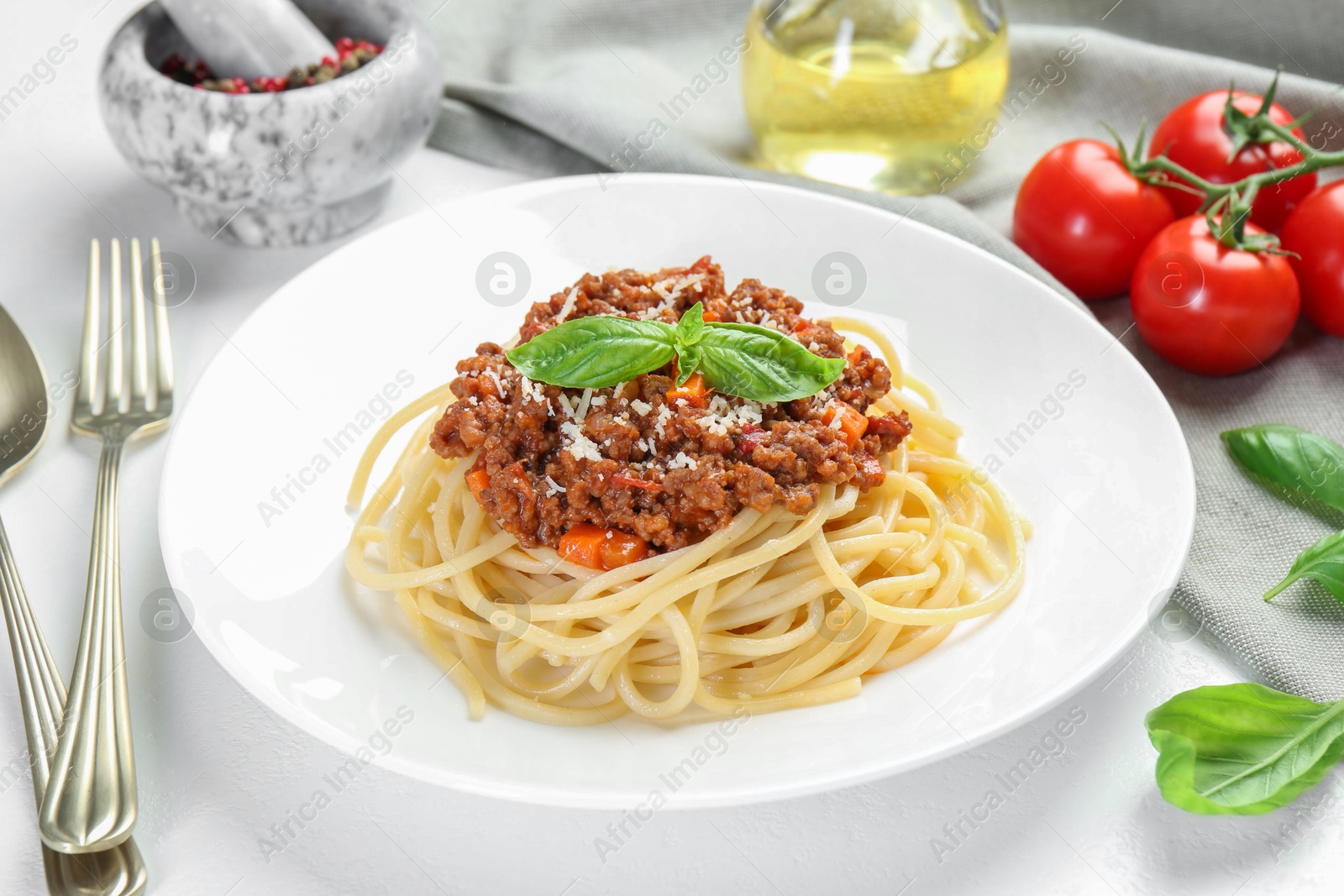 Photo of Delicious pasta bolognese served on white table