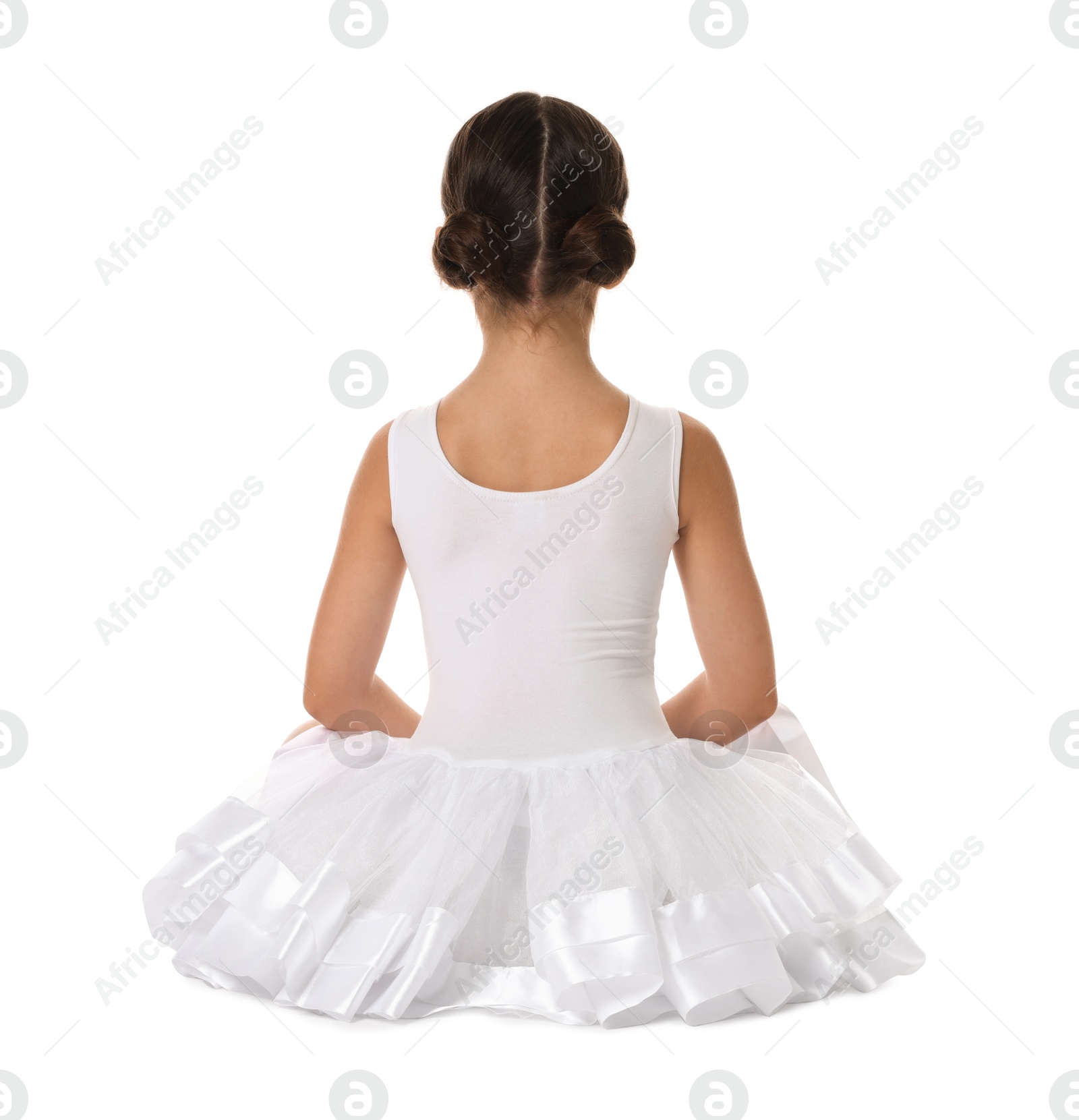 Photo of Little ballerina sitting on white background, back view