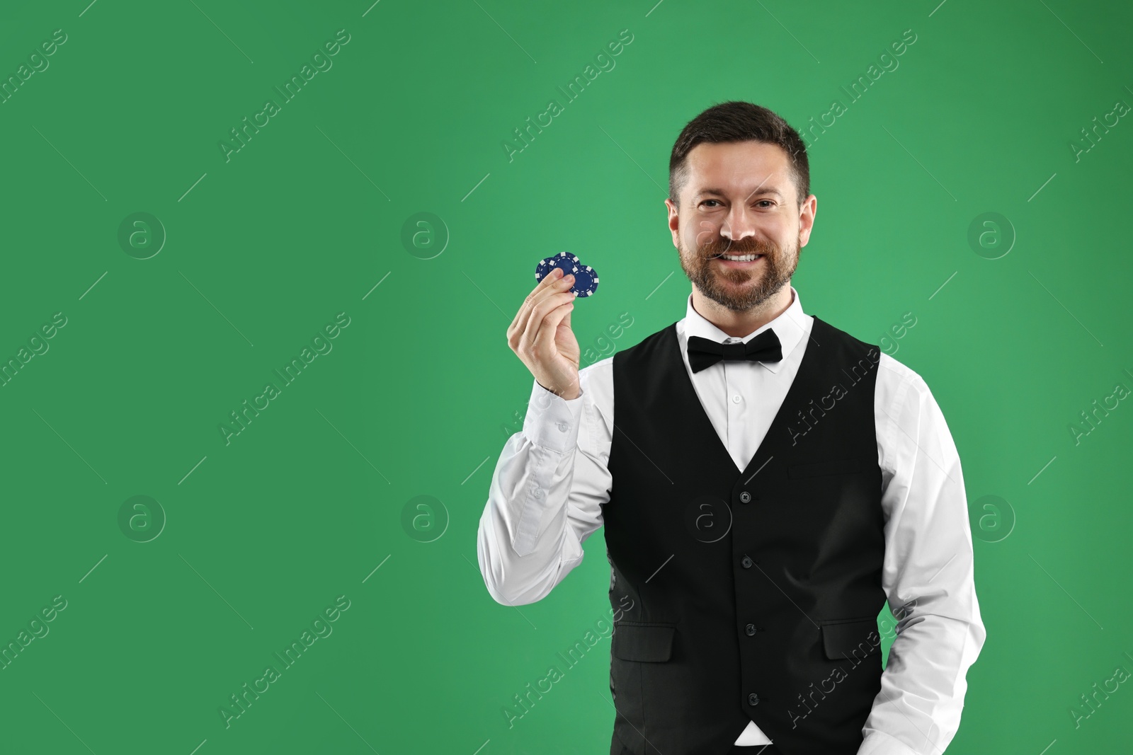 Photo of Croupier with casino chips on green background, space for text