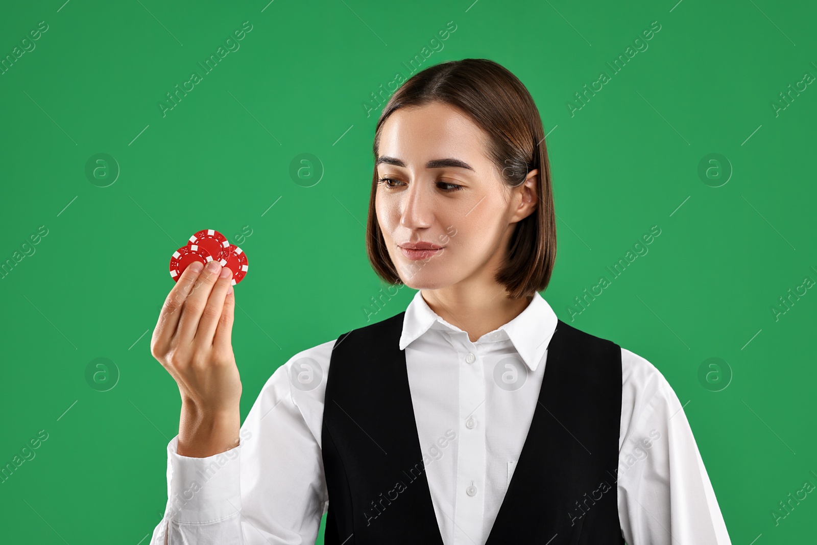 Photo of Croupier with casino chips on green background