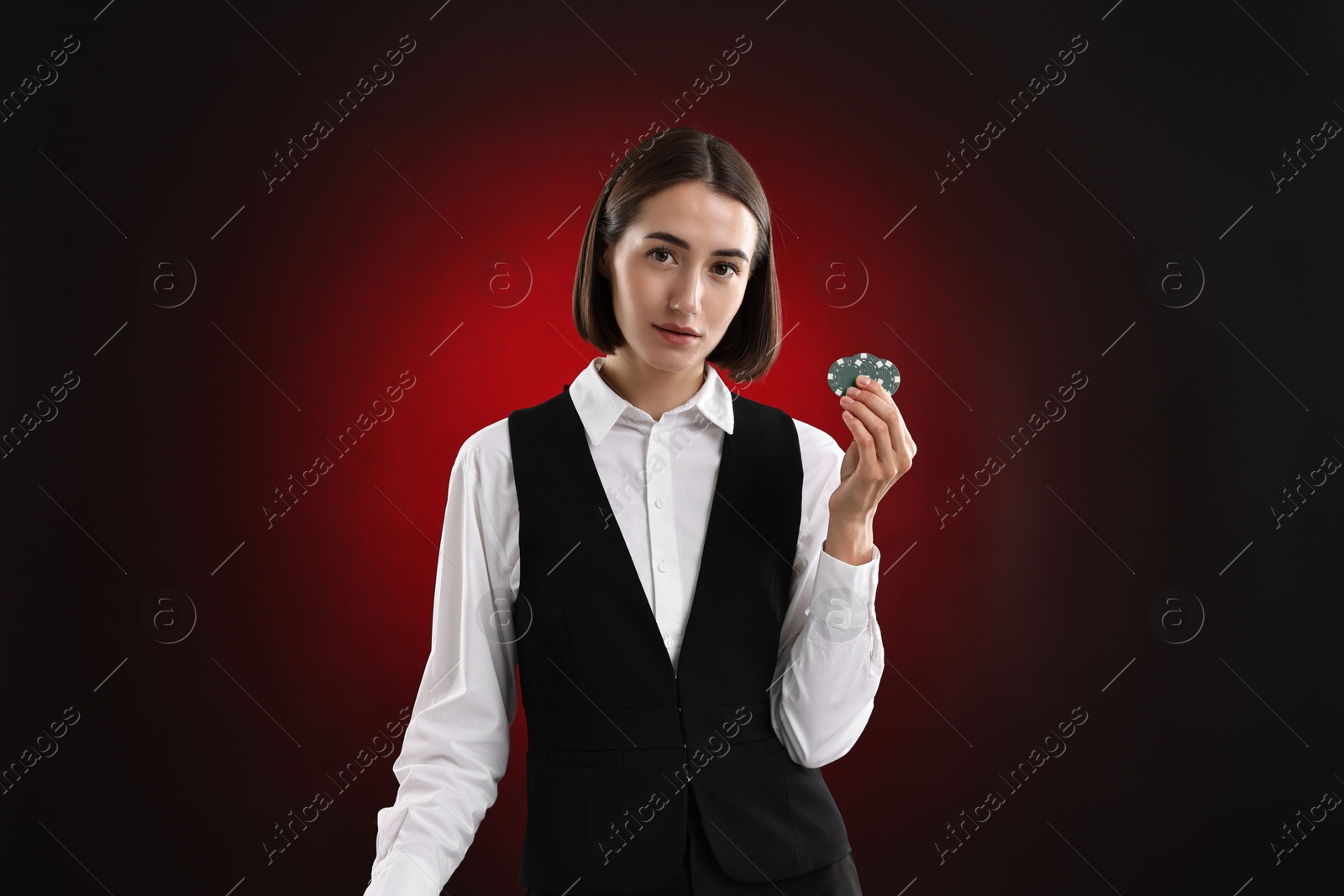 Photo of Croupier with casino chips on dark red background