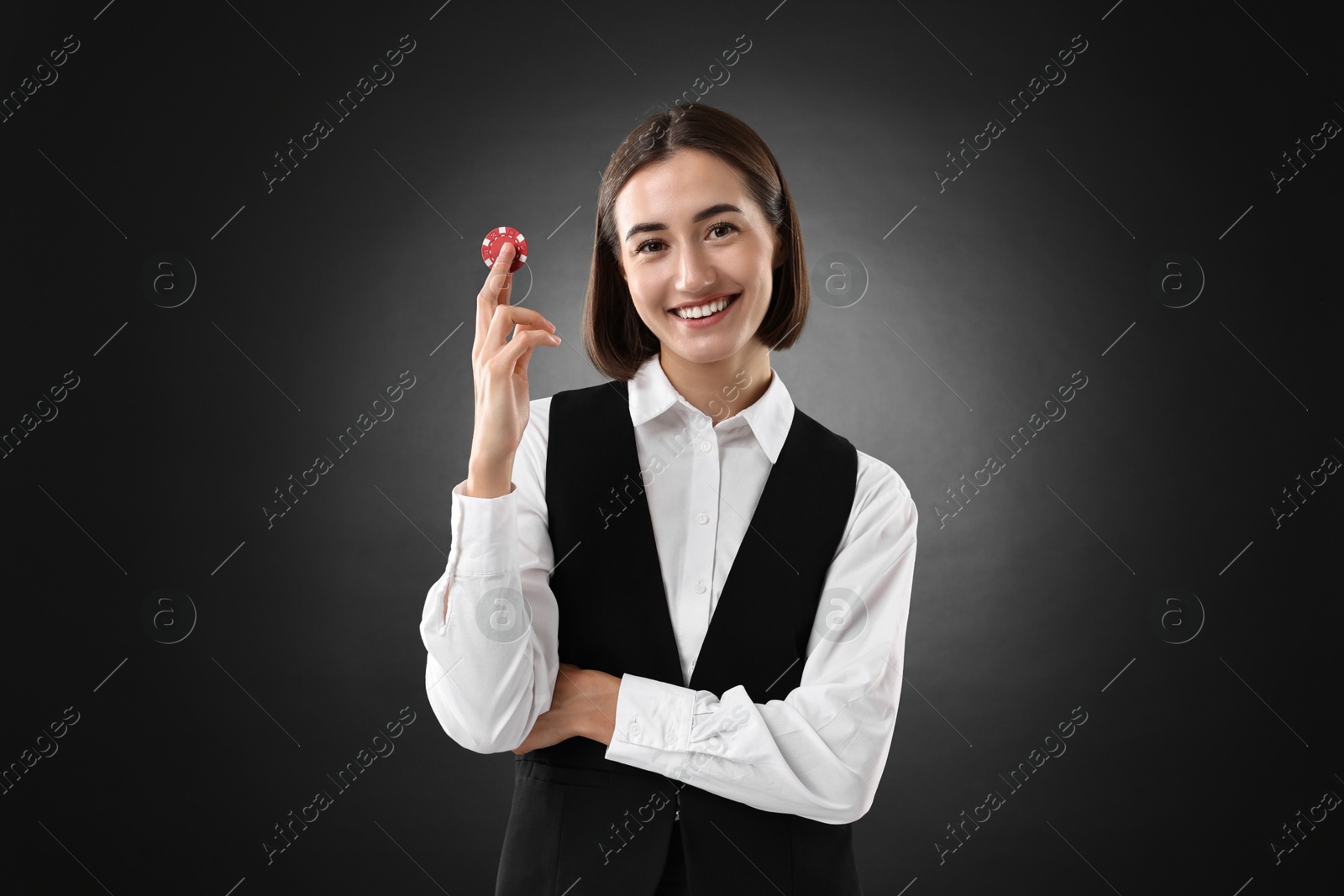 Photo of Croupier with casino chip on black background