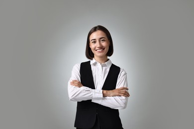 Photo of Portrait of professional croupier on grey background