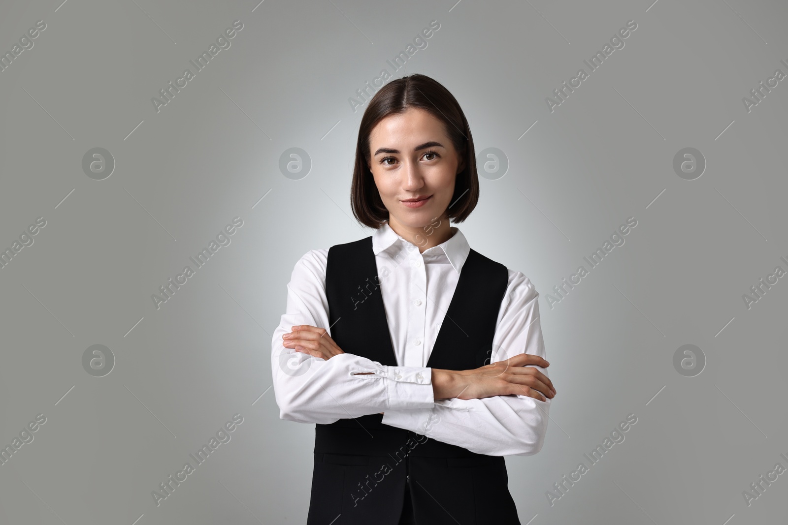 Photo of Portrait of professional croupier on grey background