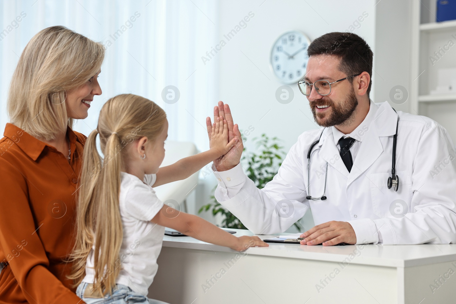 Photo of Mother and her little daughter having appointment with doctor in hospital