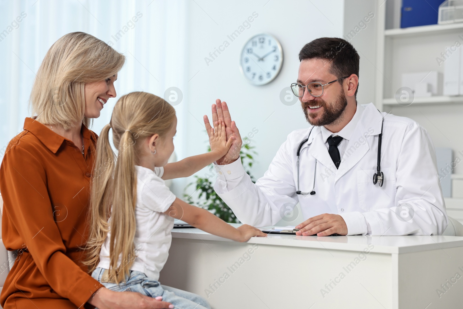 Photo of Mother and her little daughter having appointment with doctor in hospital