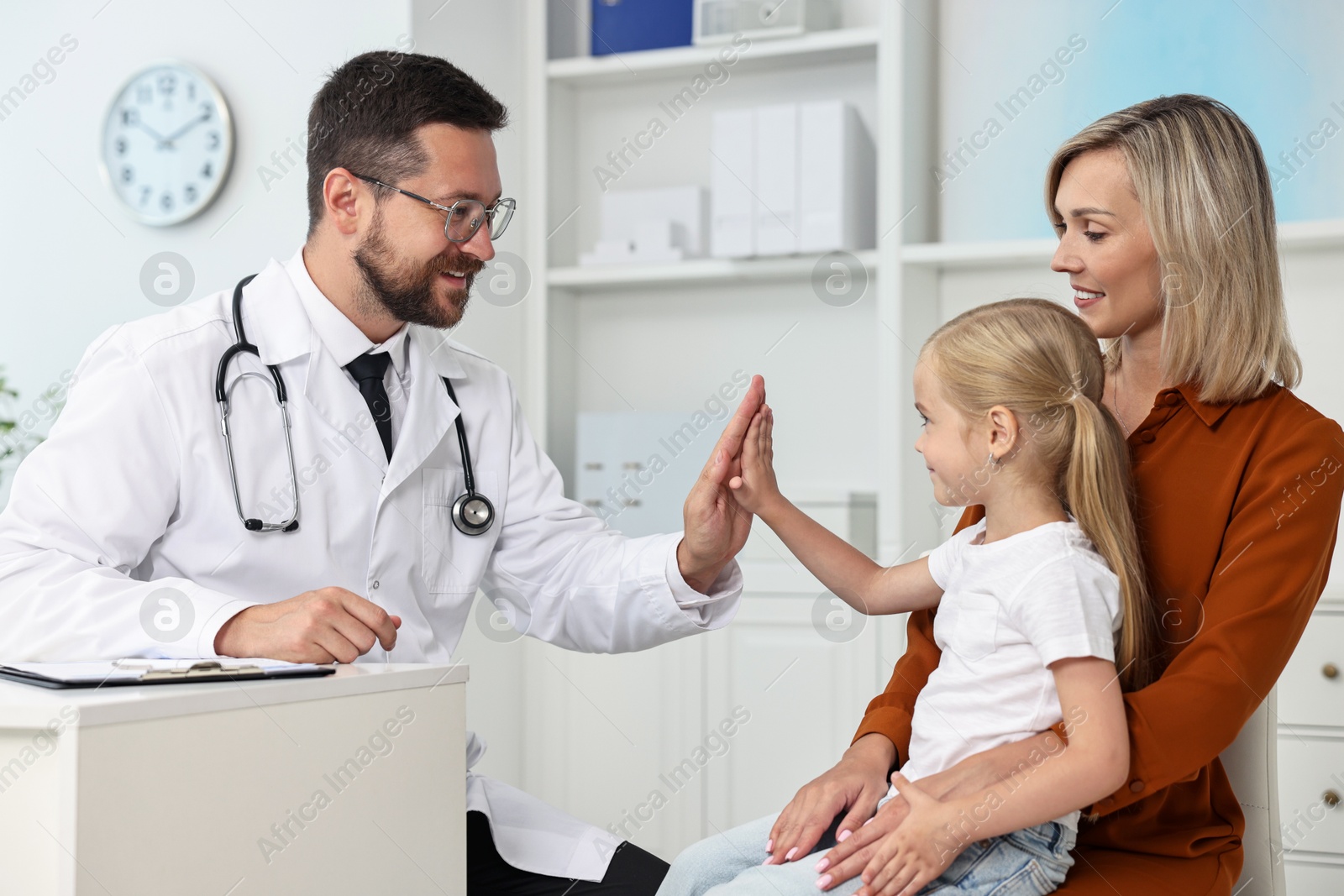 Photo of Mother and her little daughter having appointment with doctor in hospital