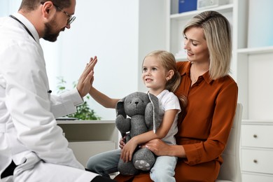 Mother and her little daughter having appointment with doctor in hospital