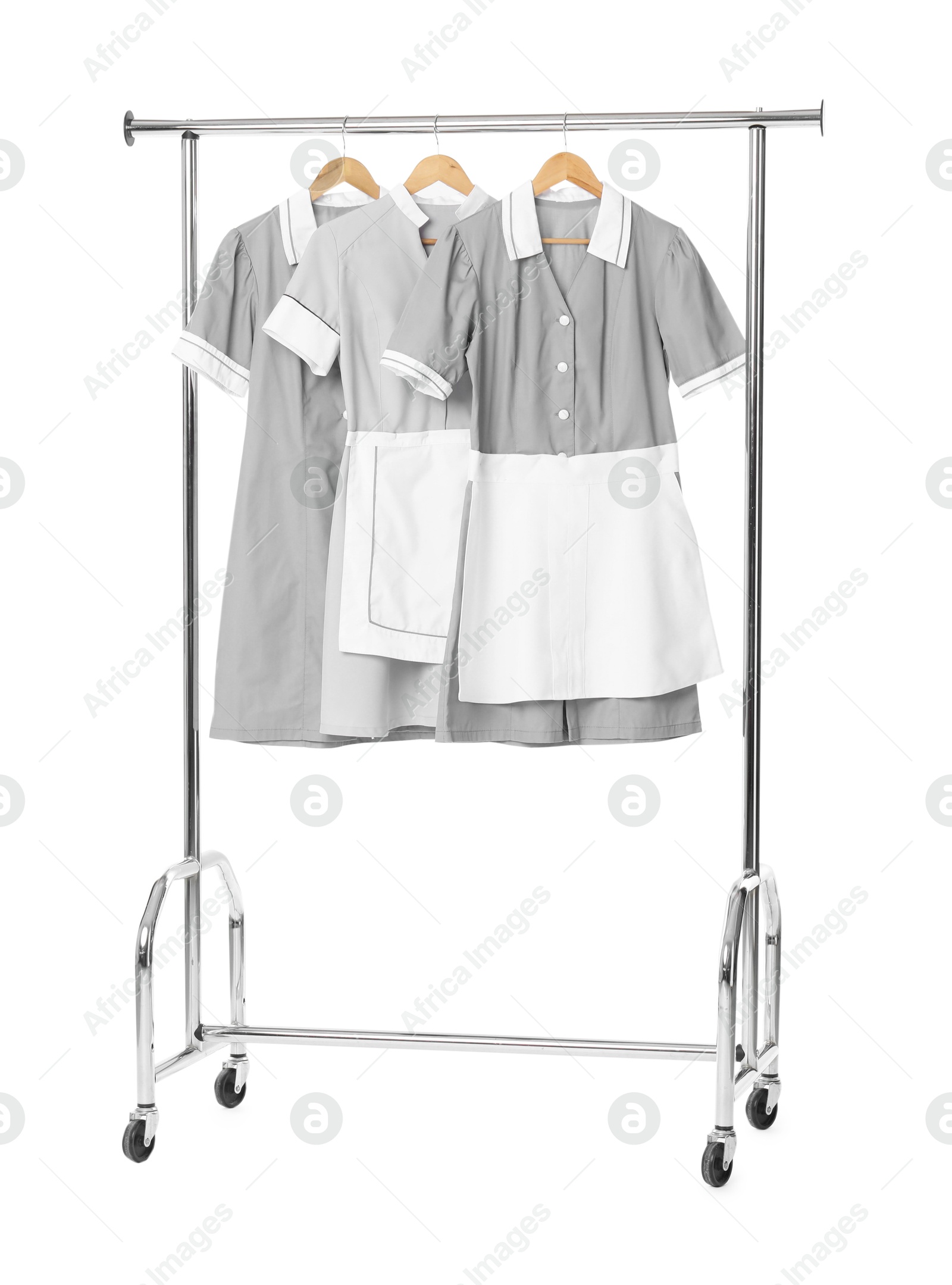 Photo of Maids' uniforms on clothing rack isolated on white