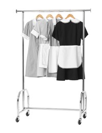 Photo of Maids' uniforms on clothing rack isolated on white