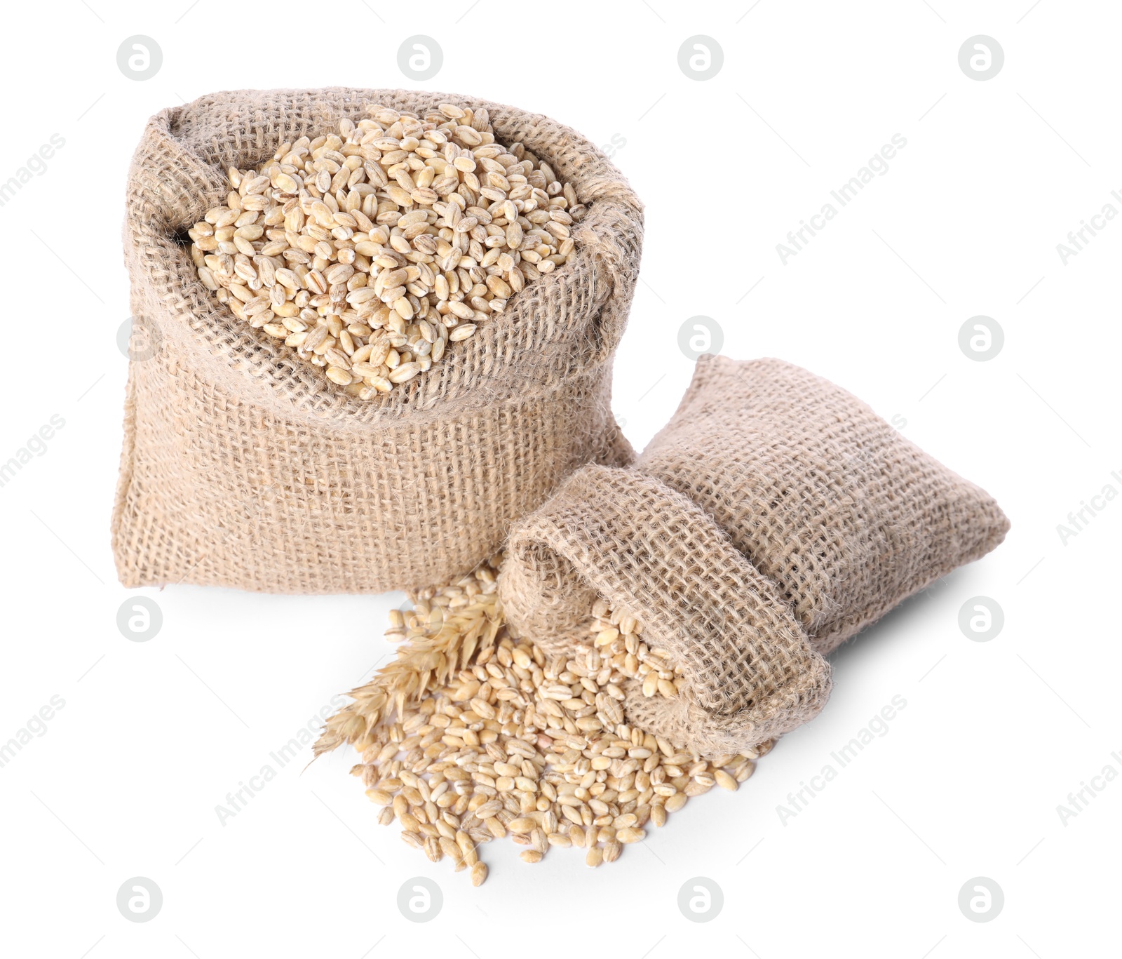 Photo of Burlap sacks with dried wheat groats isolated on white