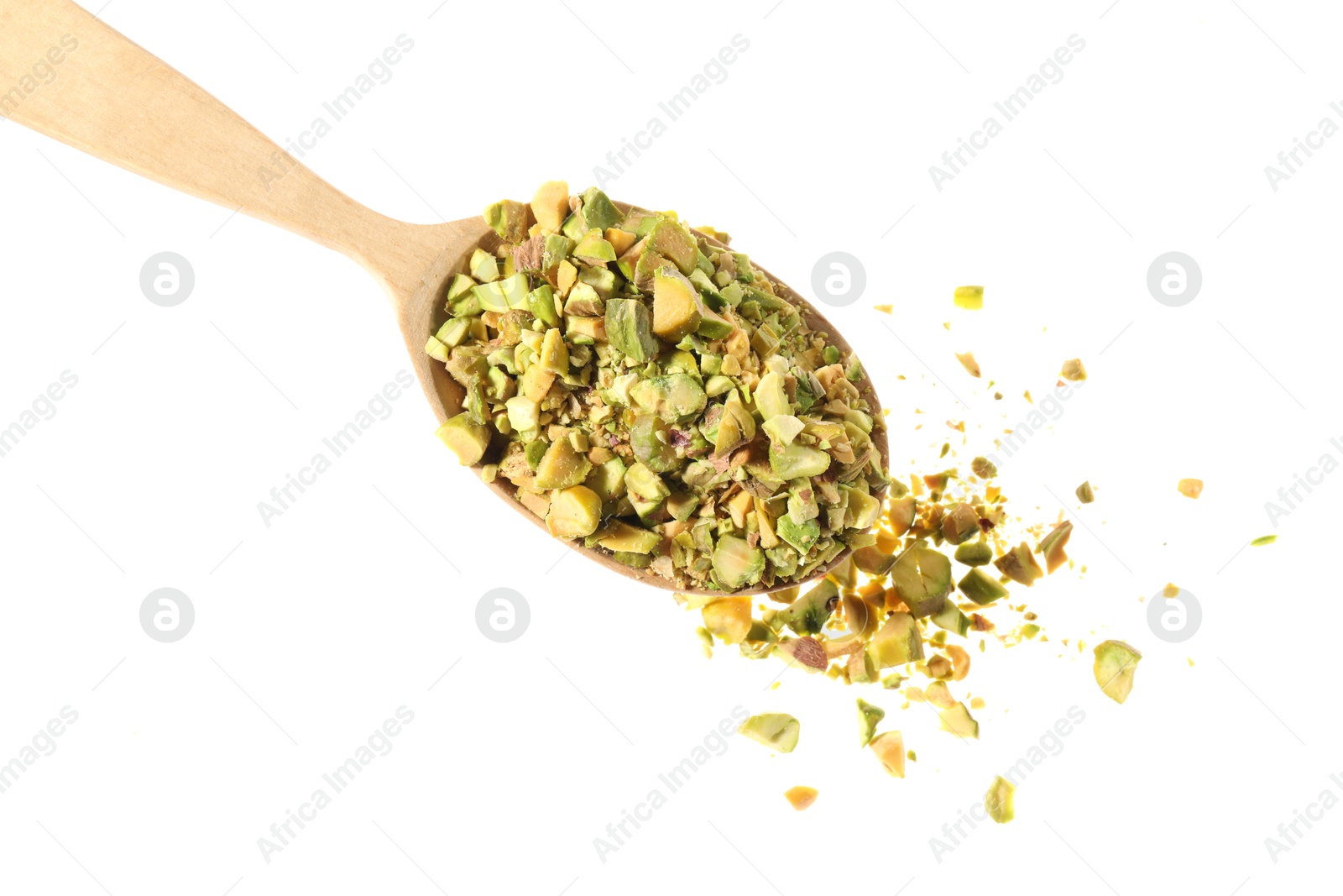 Photo of Pieces of peeled pistachio nut in wooden spoon isolated on white