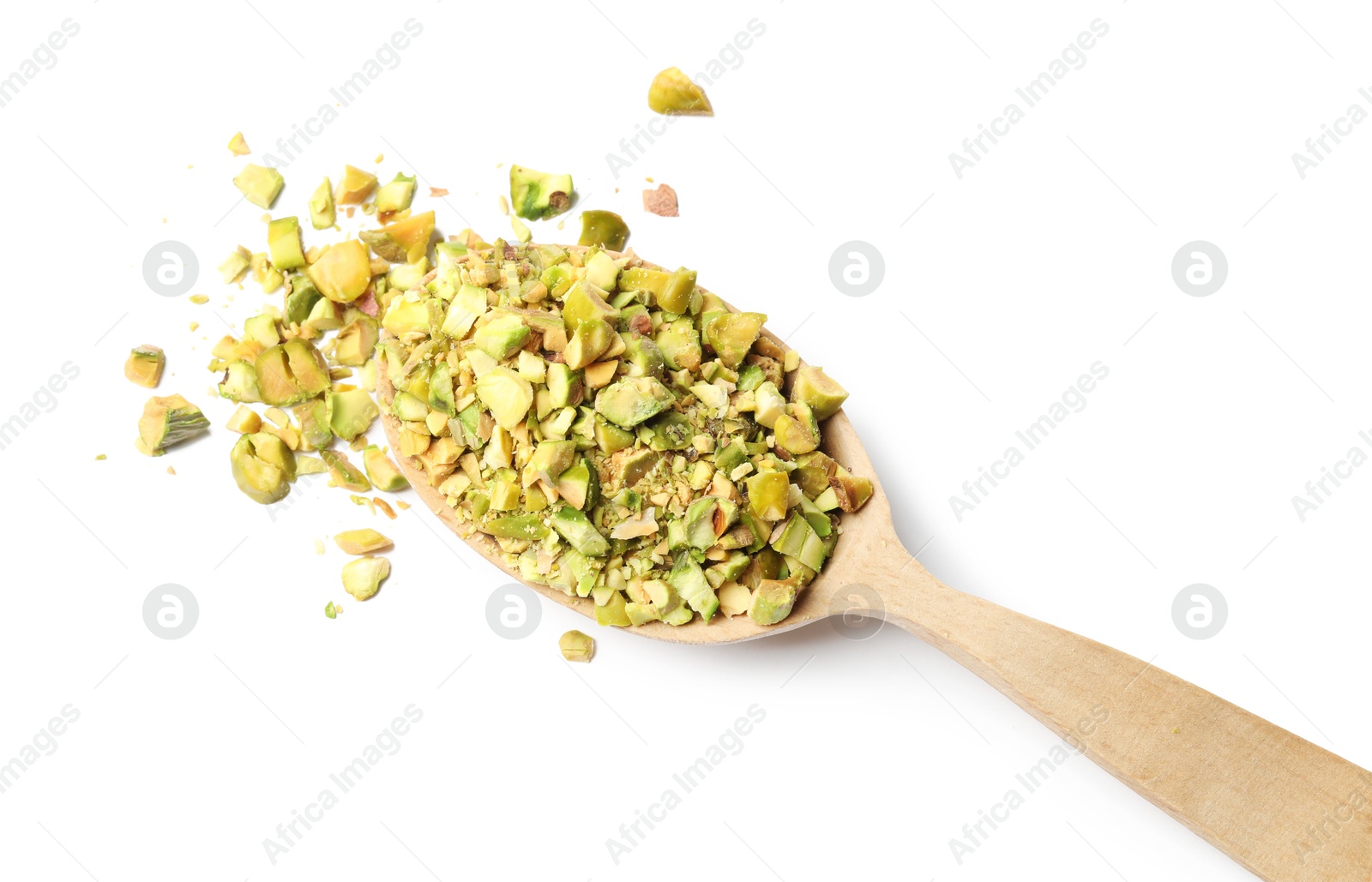 Photo of Pieces of peeled pistachio nut in wooden spoon isolated on white