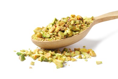 Photo of Pieces of peeled pistachio nut in wooden spoon isolated on white