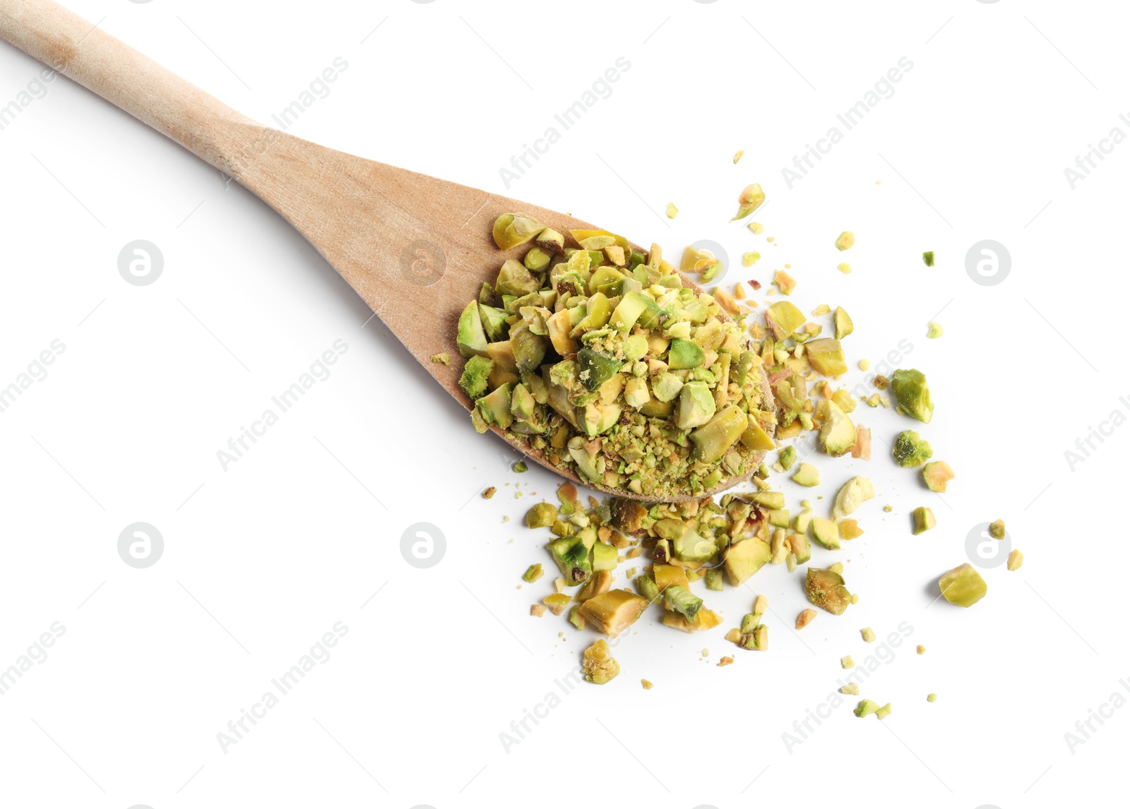 Photo of Pieces of peeled pistachio nut in wooden spoon isolated on white, top view