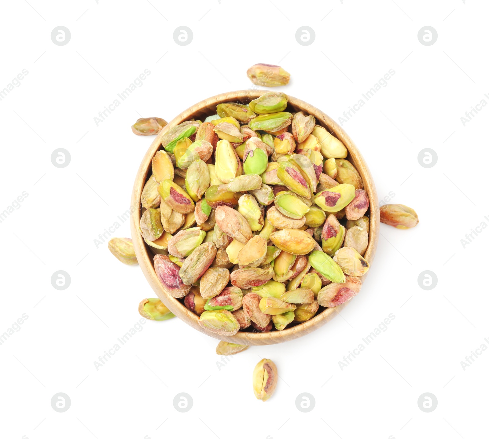 Photo of Peeled pistachio nuts in bowl isolated on white, top view