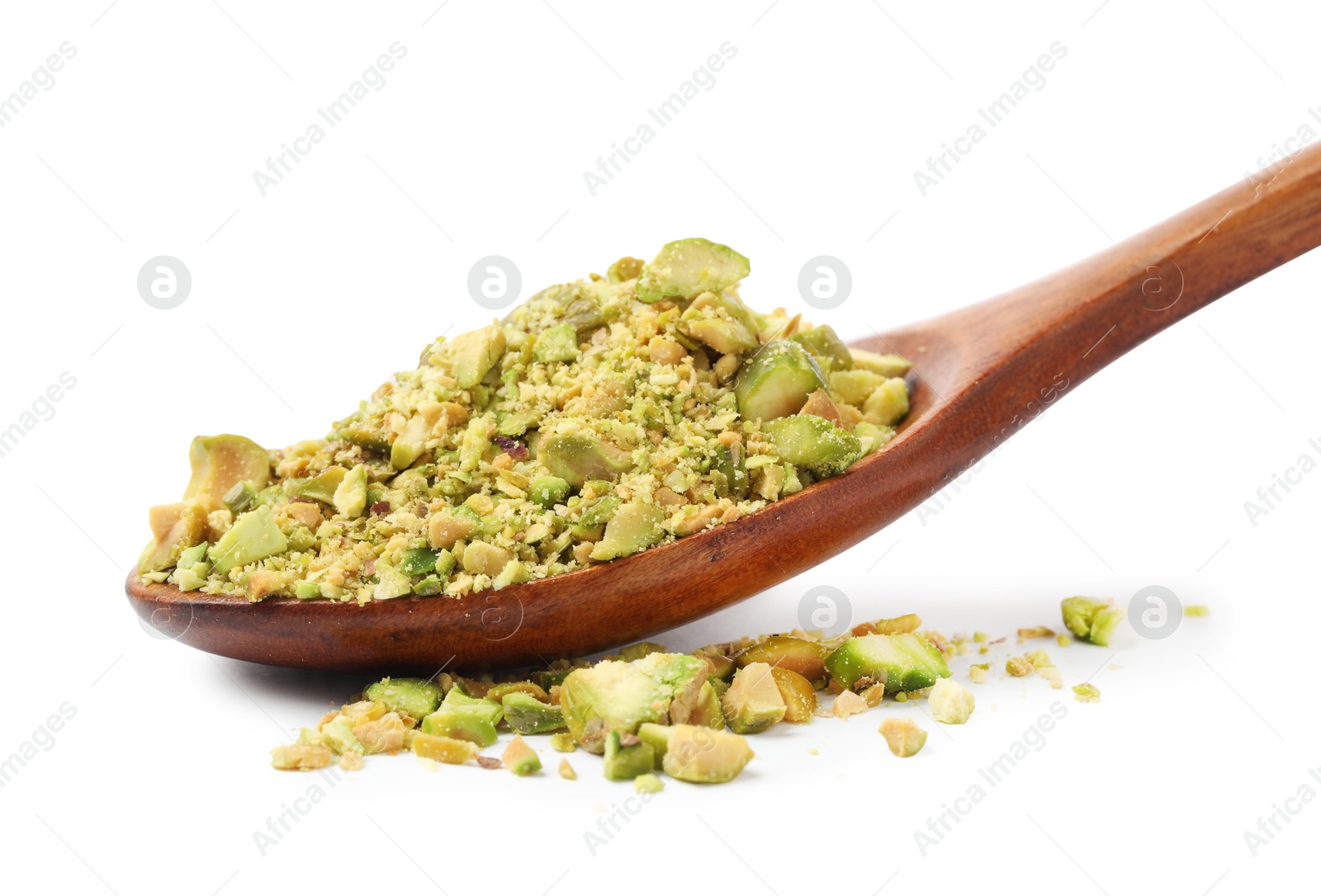 Photo of Pieces of peeled pistachio nut in wooden spoon isolated on white