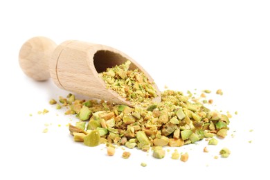 Pieces of peeled pistachio nut in wooden scoop isolated on white