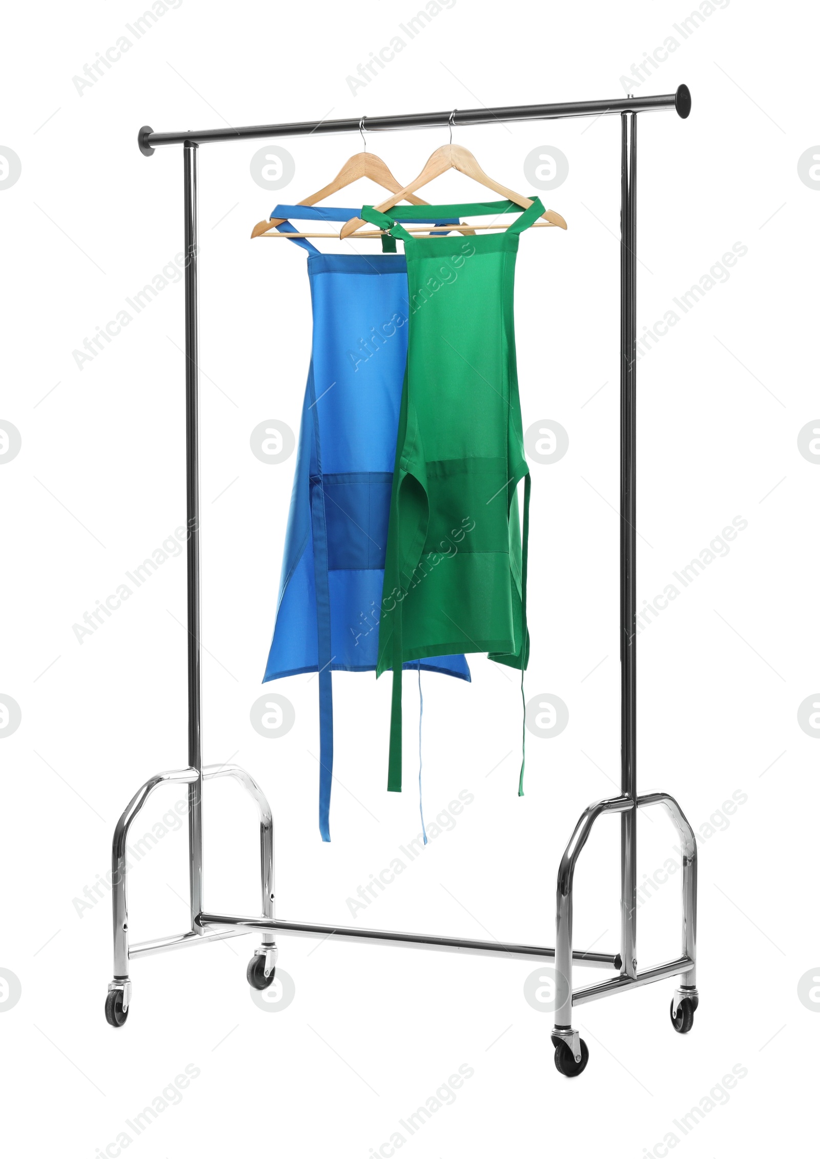 Photo of Chef's aprons on clothing rack isolated on white