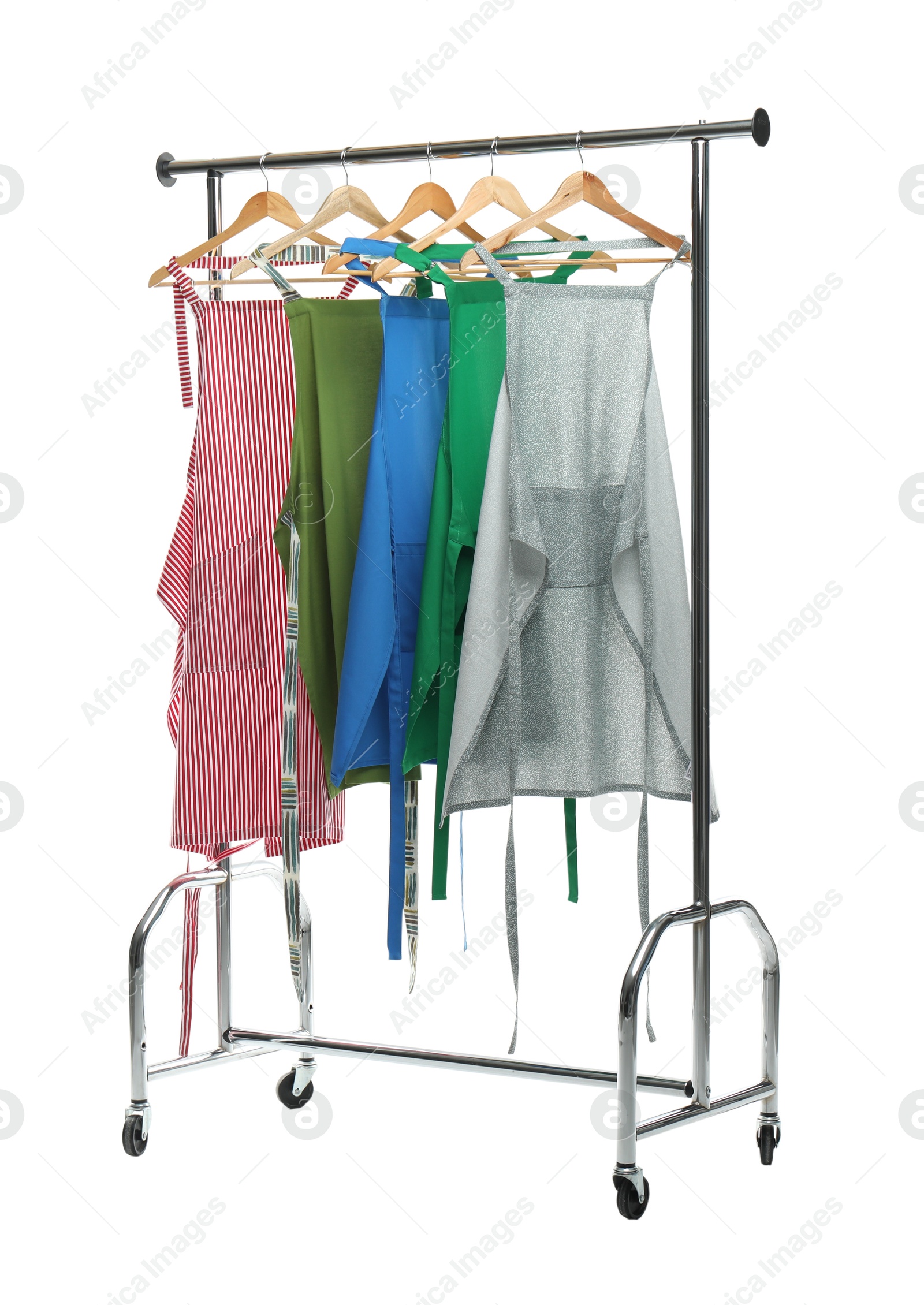 Photo of Chef's aprons on clothing rack isolated on white