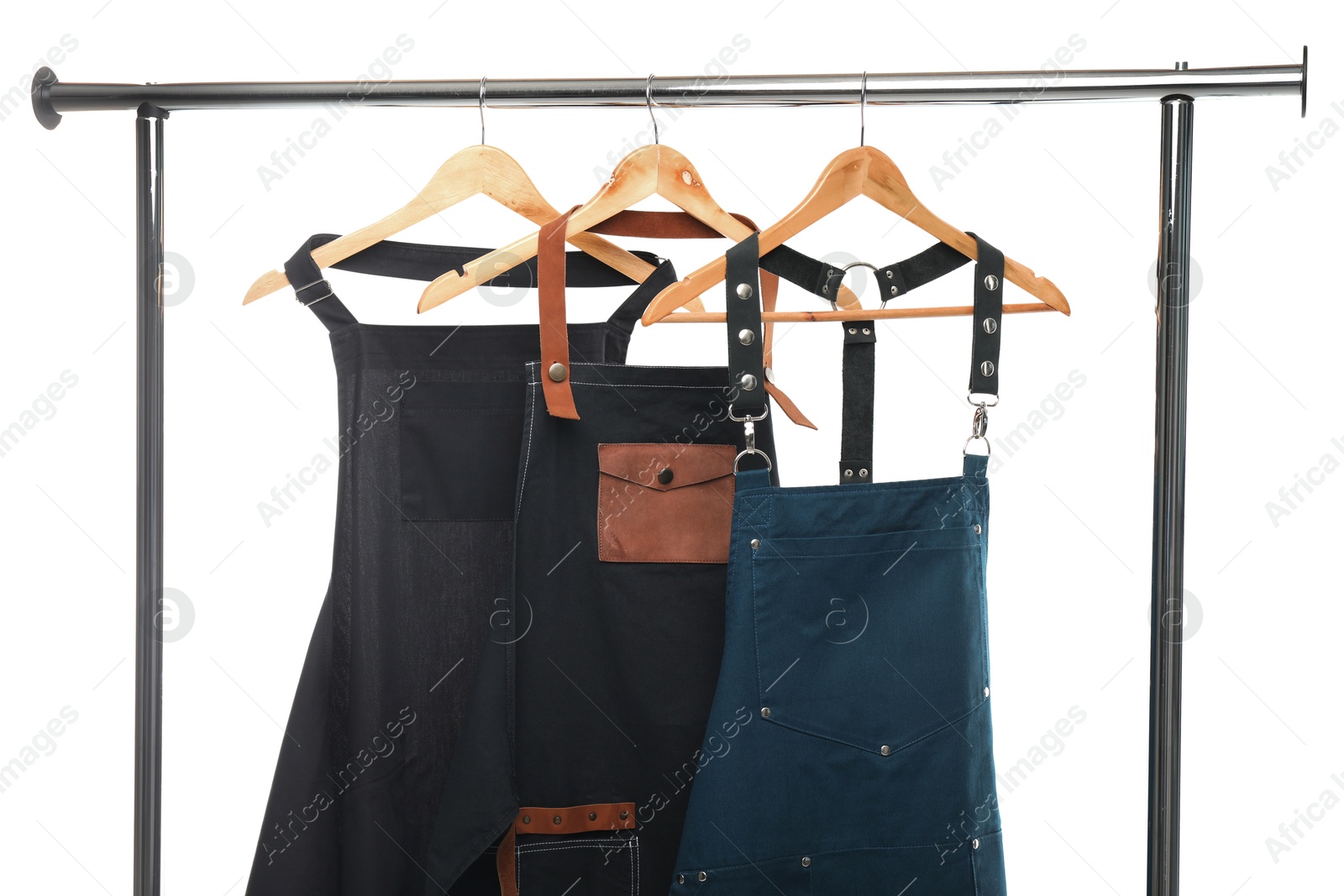 Photo of Three aprons on clothing rack isolated on white