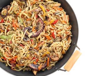 Photo of Stir-fry noodles with sea food and vegetables in wok isolated on white, top view