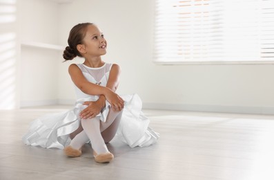 Photo of Portrait of little ballerina indoors, space for text