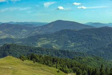 Photo of Picturesque view of mountains with trees under sky